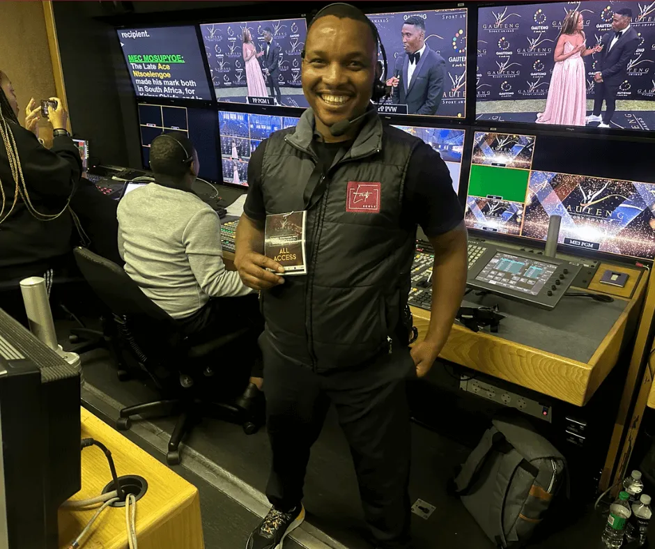 Crew member with an all-access pass in the broadcast control room during a live awards show